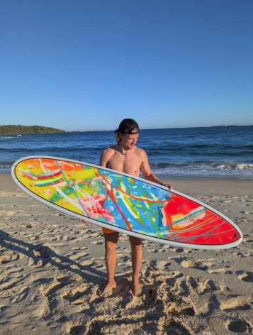 Artist Kim Tallberg with custom surfboard artwork